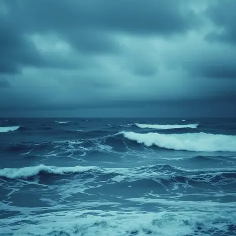 Huge waves crashing in a dark, intense ocean storm under a turbulent sky.